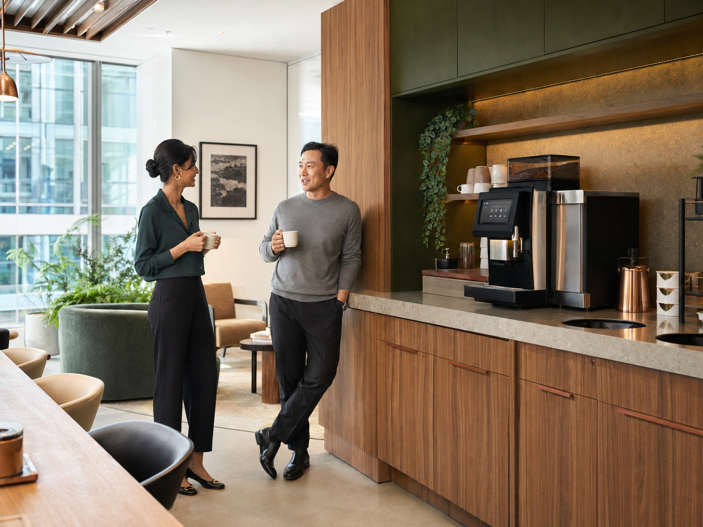 Colleagues enjoying coffee in a modern workplace lounge